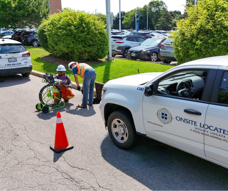 Onsite employees setting up their equipment on a side street.