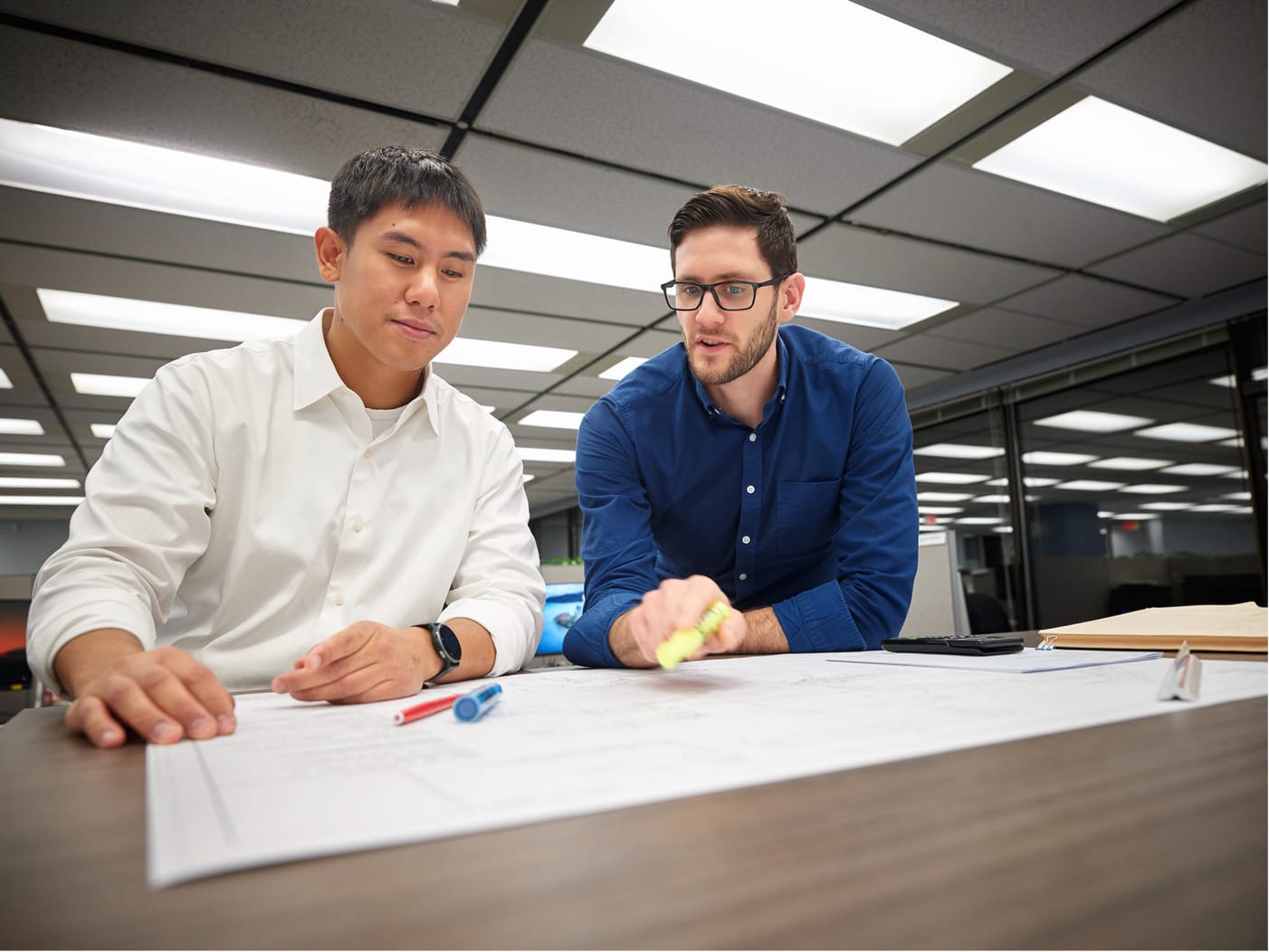 two employees at a desk